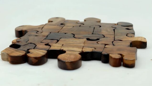 informative ultra-high-definition 4K stock video features wooden puzzle pieces arranged to spell the word FAKE on a white background representing concepts of misinformation propaganda clickbait