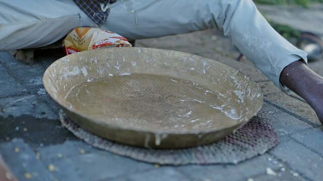 Traditional Indian Lambi Roti or Mande Being Cooked in an Earthen Pot in Unhygienic Conditions