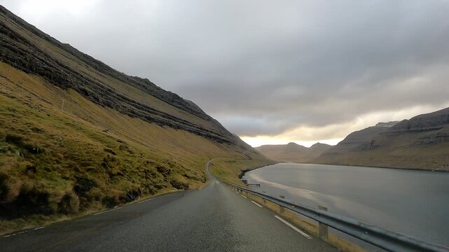 A typical road in the Faroe Islands with waterfall