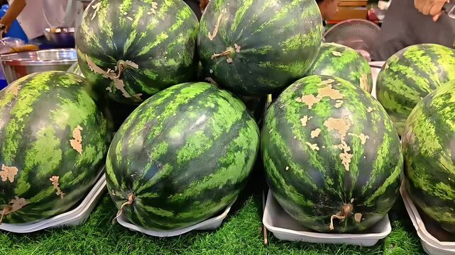 Juicy ripe watermelon stack on a market stall, Sweet Tropical Fruit, Summer Seasonal Grocery, Healthy Diet Food, Panning Shot