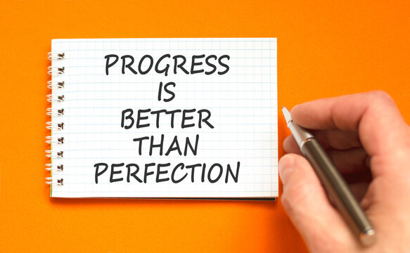 Progress or perfection words symbol. Concept words Progress is better than perfection on beautiful white note. Beautiful orange background. Business progress or perfection concept. Copy space.