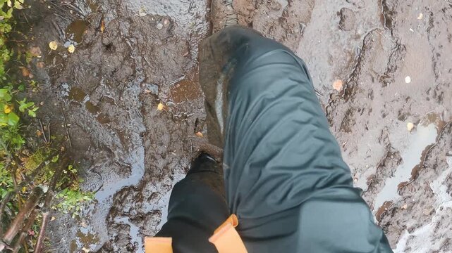 POV of hiker walking through deep mud in Norway
