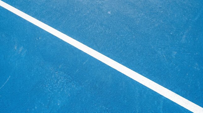 Minimalist overhead view of a textured blue sports court with a clean white diagonal boundary line for athletic brand marketing, UI design backgrounds, and sports presentations.