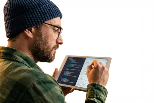 Programmer using a tablet to design a website interface