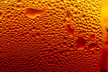 Golden Condensation Droplets on Cold Glass Surface Background,Macro,Close-up macro abstract background of water condensation and tiny water droplets covering a cold glass surface with vibrant warm gol © banjongseal324