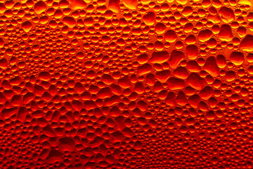 Golden Condensation Droplets on Cold Glass Surface Background,Macro,Close-up macro abstract background of water condensation and tiny water droplets covering a cold glass surface with vibrant warm gol © banjongseal324