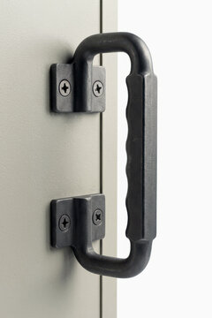 Black industrial handle on a gray metal door