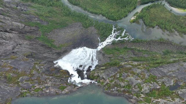 Aerial view of massive waterfall, V&aelig;rivassfossen, and lake in Rago National Park, Norway