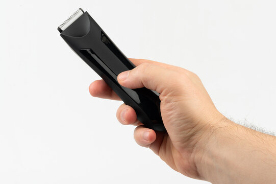 Black hair trimmer tool in hand
