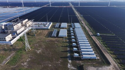 Fototapeta premium Aerial view of a large-scale photovoltaic power station with battery energy storage systems
