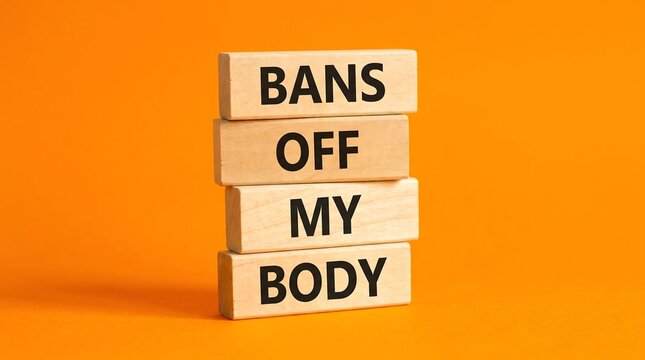 Bans Off My Body message on wooden blocks, reproductive rights and bodily autonomy concept, pro-choice activism slogan on orange background