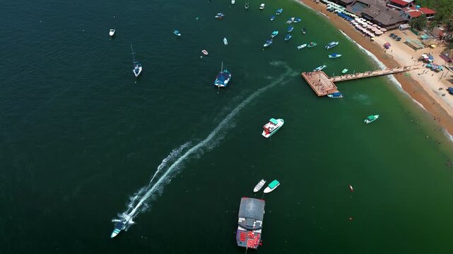 Panoramic View of Animas Beach Pier Surrounded by Tourist Boats with Swimmers in Turquoise Waters