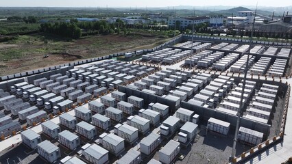 Fototapeta premium Large-scale energy storage station with rows of battery container units arranged in orderly formation