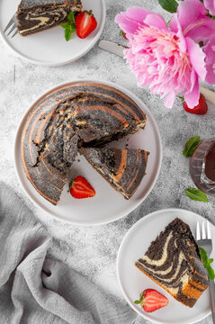 Marble cake or Zebra Pie. Cake with chocolate and vanilla layers on a white cake stand. Copy space.