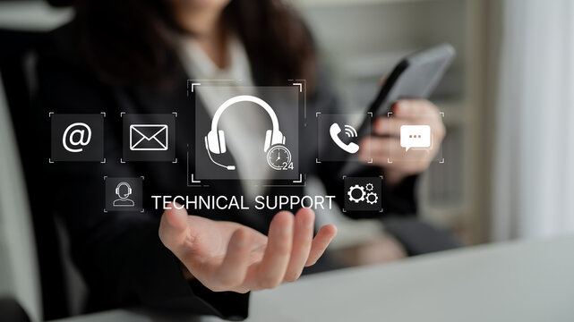 Professional woman offering technical support with digital communication icons showcasing various contact methods and assistance tools in an office setting. Bitwise.