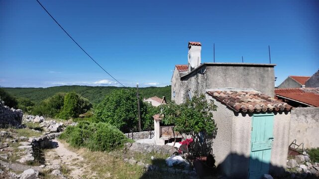 Traditional historic stone houses of Lubenice village standing on a hill overlooking the Adriatic Sea of Cres Island in Croatia. Starting point of famous trek to Sveti Ivan Beach or Lubenice Beach