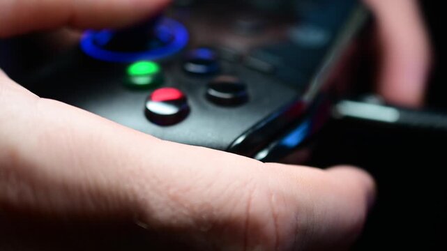 Close up of video game controller, used equipment macro detailed real time video, illuminated buttons, authentic real people activities, abstract close up.