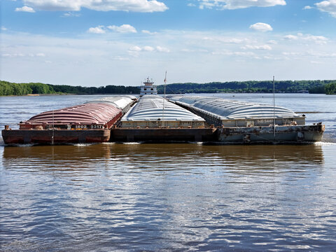 Up close front view of Tug boat pushing a set of barges on the Mississippi River