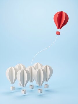 Red hot air balloon rising above white balloons, leadership