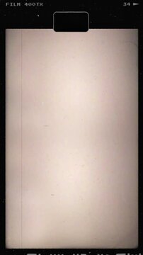 Vertical film 400TX frame overlay with super 8 sprocket hole and dust scratches. Vertical scratches, film grain, and flickering dust