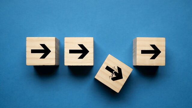 Wooden Cubes with Arrows Symbolizing Directional Divergence and Non-conformity on Blue Surface