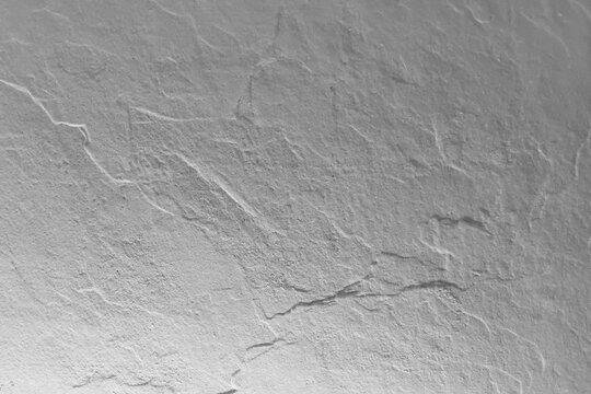 Abstract gray stone texture background with rough relief surface and natural slate rock patterns.