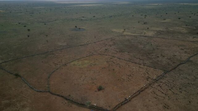 Aerial view of a large fenced livestock enclosure situated in the arid savanna landscape of Rumuruti, Laikipia County, Kenya.