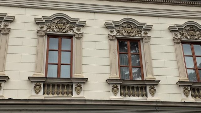 Ornate architectural details on a building facade with multiple windows
