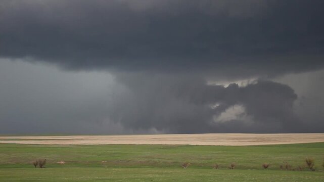 Time lapse footage of a rotating wall cloud and funnel cloud associated with a supercell thunderstorm.