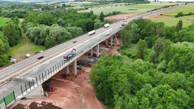 Highway bridge construction with heavy machinery - Aerial drone view