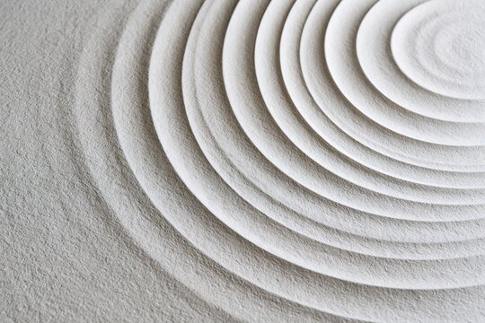 Abstract texture with concentric circles in zen sand garden style, gray