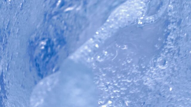 Mesmerizing underwater ocean swirl creating an abstract water texture with fluid movement and blue tones.