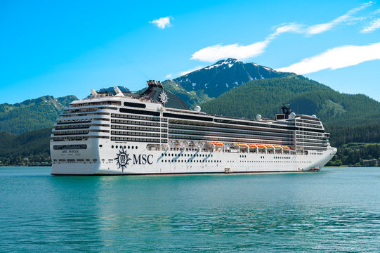 Juneau, Alaska - July 17, 2026: MSC Poesia Cruise Ship Anchored in Port of Juneau against Mountain Background. Side View. 