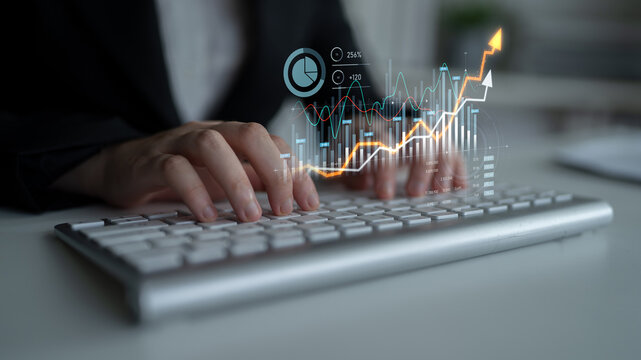 A business professional engages with financial data on a keyboard, surrounded by vibrant graphs and growth indicators displaying dynamic trends in a modern office setting. Scalp