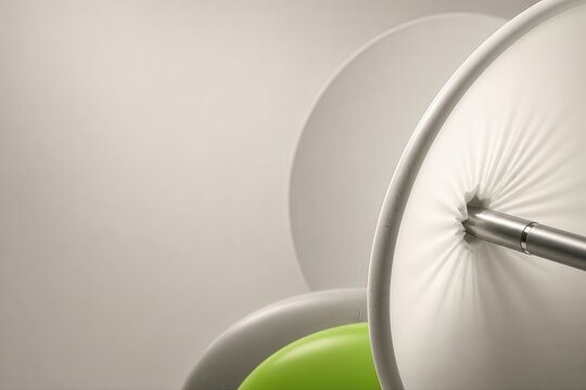 Soft white upholstered chair detail with green accent