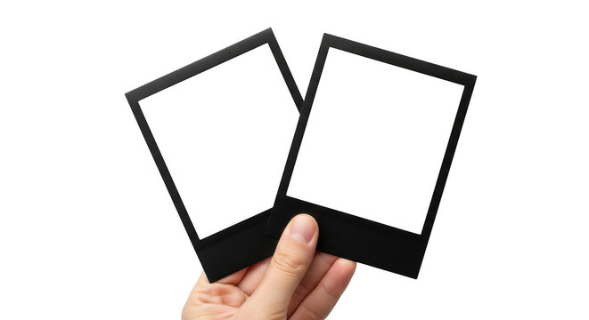 Hand holding two empty instant film photo frames isolated on transparent background