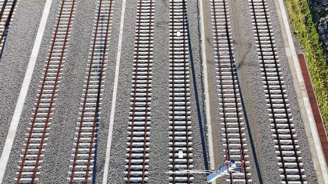Aerial view of Koralmbahn railway tracks with parallel lines and gravel ballast in Deutschlandsberg, Steiermark, Austria.