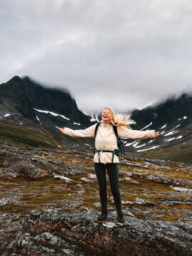 Woman traveler delighted with nature hiking solo in Norway travel adventure healthy lifestyle, autumn vacations in foggy Arctic mountains tour outdoors hiker girl enjoying landscape candid emotions