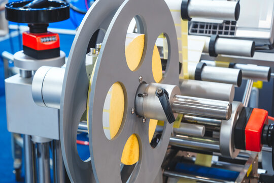 Fragment of conveyor packaging sticking labeling machine. tech industrial technology background