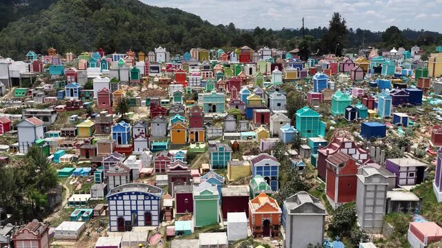 Aerial view of the vibrant, multi-colored mausoleums and tombs in the historic cemetery of Chichicastenango, Quiche Department, Guatemala.