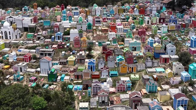 Aerial view of the colorful Chichicastenango Cemetery with vibrant mausoleums and tombs nestled in the hills of Chichicastenango, Quiche Department, Guatemala.