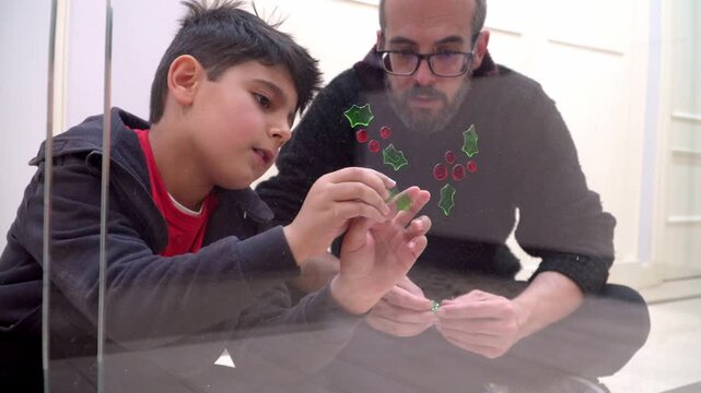 father and son on a christmas family activity at home