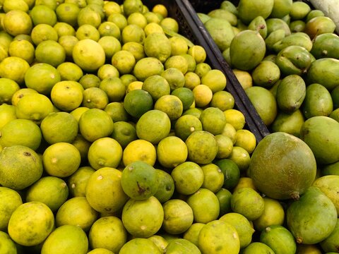 green lemons in a market