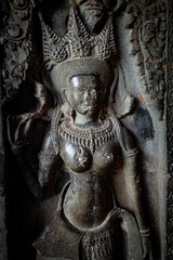 Fototapeta premium Ancient stone carving of a female Apsara dancer inside Angkor Wat temple in Siem Reap, Cambodia
