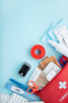 First aid kit contents arranged on light blue background