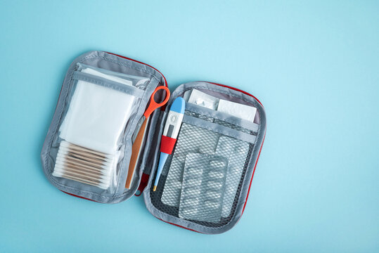 First aid kit contents isolated on blue background
