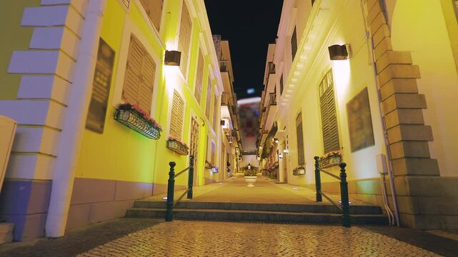 Charming illuminated street at night in Macau