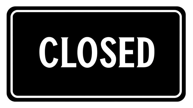 A black and white sign reads CLOSED in bold white letters. The sign has a white border around the black rectangular background
