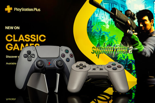 August 4, 2026, Odessa, Ukraine.  Sony PS5 30th Anniversary controller and original PS1 gamepad on Syphon Filter 2 back