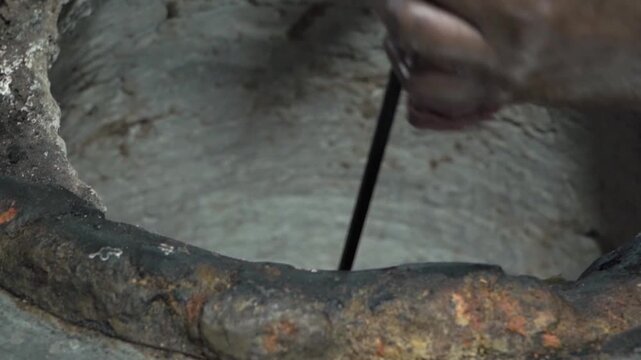 Close up of chef preparing spicy marinated chicken tikka on skewers for authentic tandoor cooking at an Indian restaurant.